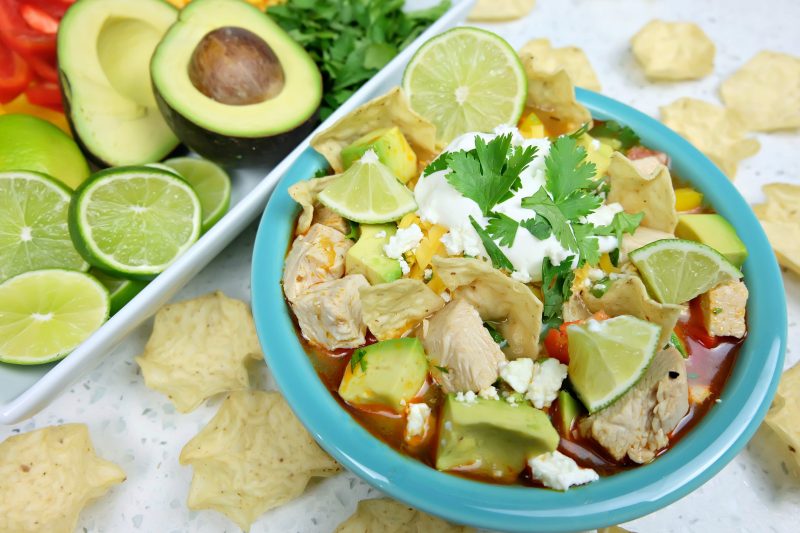 Take those Christmas or Thanksgiving Turkey Leftovers and turn them into an incredibly delicious and healthy meal your family will love with this Turkey Tortilla Soup Recipe! Perfect to warm you up on a cool day! #Sponsored #Turkey #Soup #Recipe #TurkeyTraditions