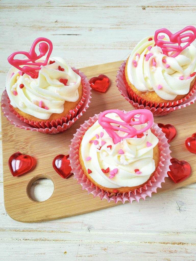 Looking for an easy, last minute Valentine's Day treat idea? Check out these Easy Valentine's Day Cupcakes! Made with a vanilla cake mix, these get their wow factor from diy edible candy hearts on top! Fun for baking with kids! #ValentinesDay #Cupcakes #Baking #BakingWithKids