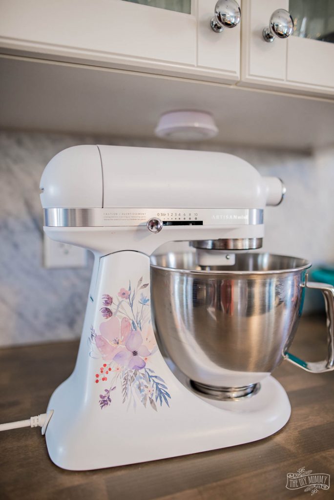 Update your kitchen aid mixer with a watercolor floral design cut with the Print and Cut function on the Cricut. 