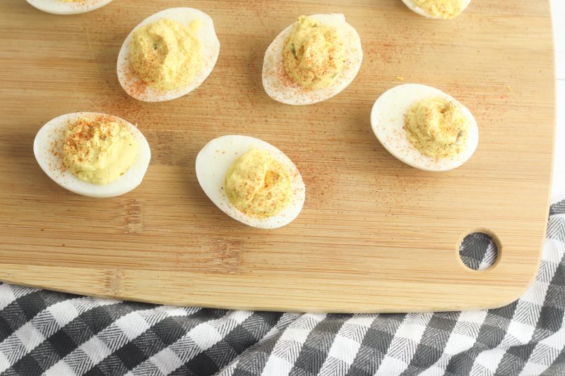 Use up those leftover Easter hardboiled eggs with this easy and yummy greek yogurt devilled egg recipe! If made with non-fat yogurt they make a zero point weight watchers snack! A delicious and easy appetizer to make when entertaining. Perfect for Easter brunch. A healthy, family friendly snack packed with protein! #Easter #Recipe #DevilledEggs #Eggs #Snack #Appetizer 