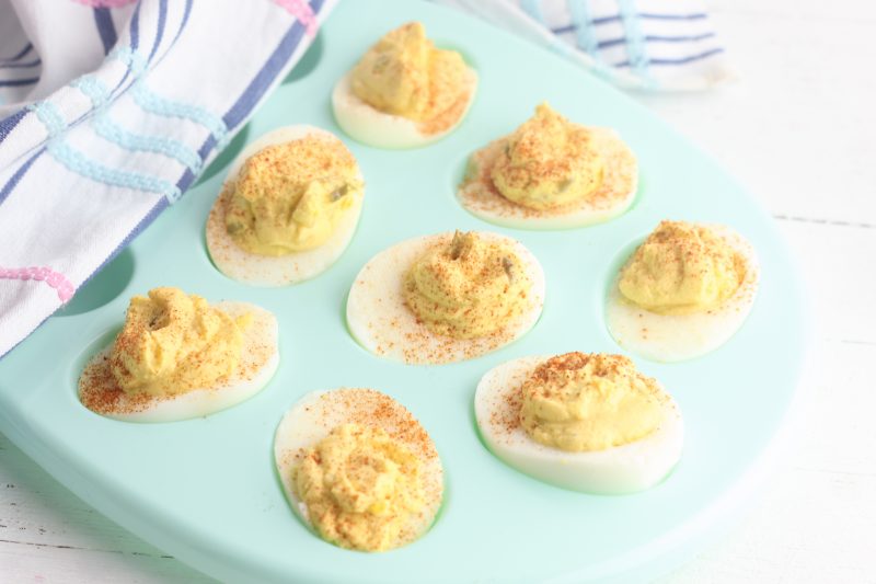 Use up those leftover Easter hardboiled eggs with this easy and yummy greek yogurt devilled eggs recipe! If made with non-fat yogurt they make a zero point weight watchers snack! A delicious and easy appetizer to make when entertaining. Perfect for Easter brunch. A healthy, family friendly snack packed with protein! #Easter #Recipe #DevilledEggs #Eggs #Snack #Appetizer 