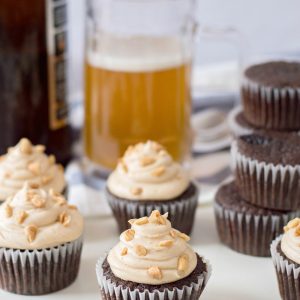 The perfect dessert to steal a man's heart-- our Chocolate Beer Cupcakes Recipe! With chocolate and beer in the batter, a peanut butter buttercream frosting and salty peanuts sprinkled on top, this recipe is the ultimate dad dessert! Perfect for Father's Day, birthdays and just because! #Cupcakes #Beer #Recipe #BeerRecipe #ChocolateCupcakes #FathersDay #Dessert #FathersDayCupcakes #FathersDayDessert #BeerRecipes