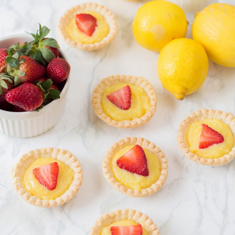 The perfect summer dessert recipe! Looking for a strawberry recipe to make with your summer berries? This one with have your mouth watering-- It's a Strawberry Lemon Tarts Recipe that is family friendly and delicious! Perfect for tea parties and summer desserts! #Strawberries #Baking #StrawberryRecipe #Recipes #Tarts #Pie #Homemade #StrawberryTart #StrawberryPie