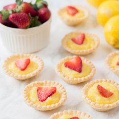 The perfect summer dessert recipe! Looking for a strawberry recipe to make with your summer berries? This one with have your mouth watering-- It's a Strawberry Lemon Tarts Recipe that is family friendly and delicious! Perfect for tea parties and summer desserts! #Strawberries #Baking #StrawberryRecipe #Recipes #Tarts #Pie #Homemade #StrawberryTart #StrawberryPie