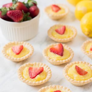 The perfect summer dessert recipe! Looking for a strawberry recipe to make with your summer berries? This one with have your mouth watering-- It's a Strawberry Lemon Tarts Recipe that is family friendly and delicious! Perfect for tea parties and summer desserts! #Strawberries #Baking #StrawberryRecipe #Recipes #Tarts #Pie #Homemade #StrawberryTart #StrawberryPie