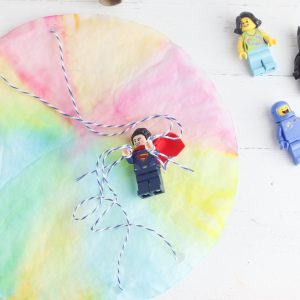 Looking for a DIY Lego Craft Idea? These DIY Lego Superhero Parachutes are fun and easy to make with supplies you probably already have at home! Make for Lego Star Wars characters, Lego Minecraft Characters, Superhero Lego Characters and more! Great lego crafts for birthday parties! #Lego #Crafts #LegoBirthday #LegoCrafts #LegoIdeas #CraftProjects #KidsCrafts