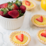 The perfect summer dessert recipe! Looking for a strawberry recipe to make with your summer berries? This one with have your mouth watering-- It's a Strawberry Lemon Tarts Recipe that is family friendly and delicious! Perfect for tea parties and summer desserts! #Strawberries #Baking #StrawberryRecipe #Recipes #Tarts #Pie #Homemade #StrawberryTart #StrawberryPie