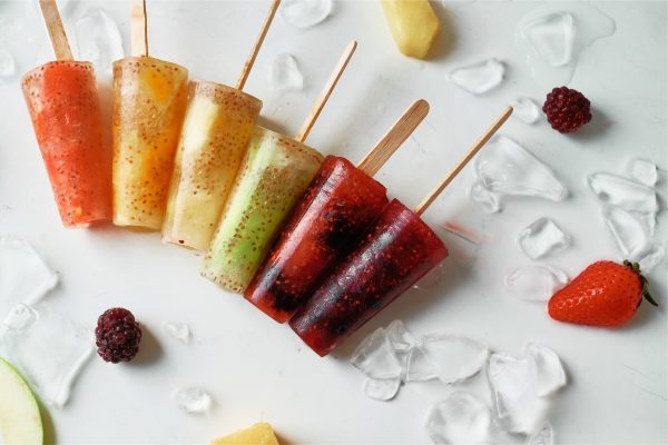 Make popsicles at home that you can feel good about serving your kids with this delicious healthy rainbow ice pops recipe! Made with juice, chia seeds and fresh fruits the flavor and color combinations are endless with this easy treat! #icepops #chiaseeds #healthysnack #recipe #fruit #rainbow #rainbowfood #homemade
