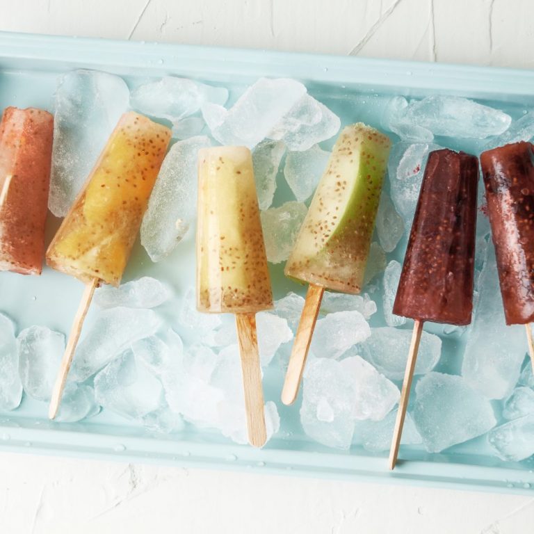 Make popsicles at home that you can feel good about serving your kids with this delicious healthy rainbow ice pops recipe! Made with juice, chia seeds and fresh fruits the flavor and color combinations are endless with this easy treat! #icepops #chiaseeds #healthysnack #recipe #fruit #rainbow #rainbowfood #homemade