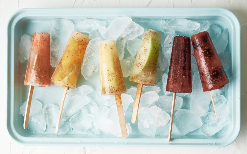 Make ice pops at home that you can feel good about serving your kids with this delicious healthy rainbow popsicles recipe! Made with juice, chia seeds and fresh fruits the flavor and color combinations are endless with this easy treat! #icepops #chiaseeds #healthysnack #recipe #fruit #rainbow #rainbowfood #homemade