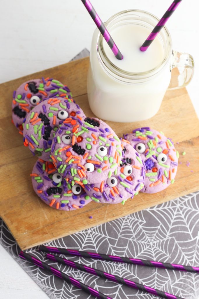 They're creepy and they're kookie, they're all together spooky! Grab this easy Monster Mash Halloween Sugar Cookie Recipe for baking with kids! Perfect for family Halloween fun and classroom Halloween party snack ideas! #Recipe #cookies #Halloween #Monster #PurpleFood #FamilyFriendly #CookingWithKids #Homemade