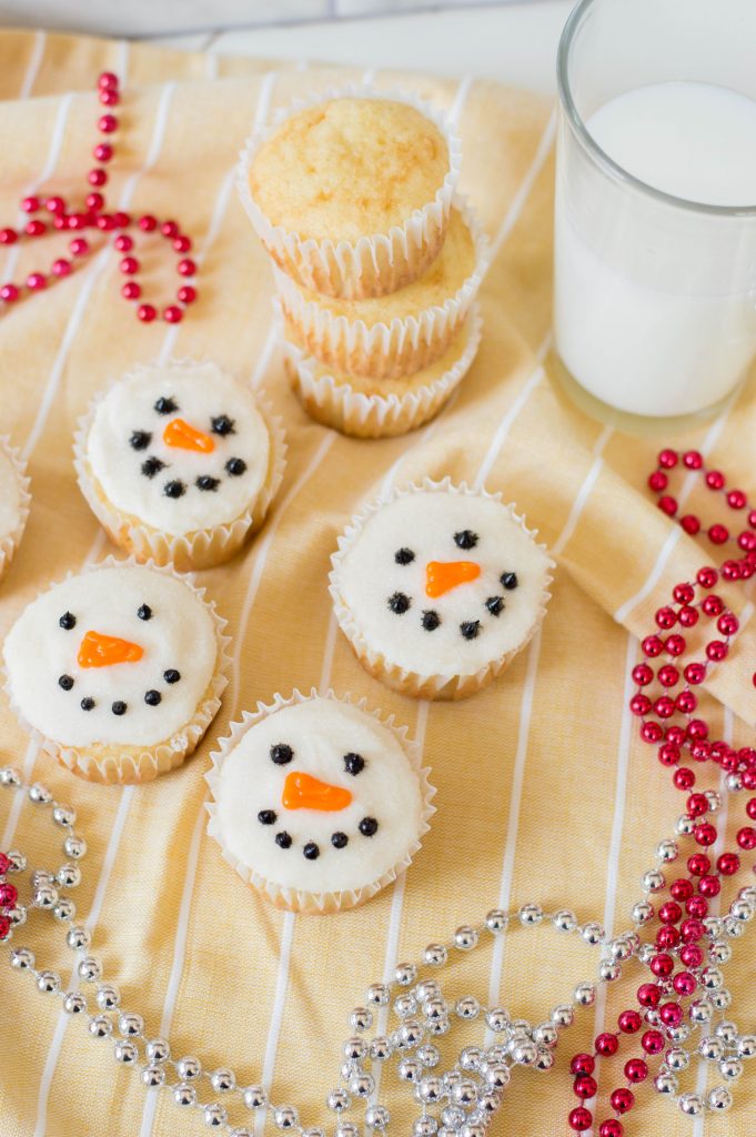 These adorable sparkly snowman cupcakes are the perfect recipe for Christmas baking with kids! This fun and easy cupcake recipe uses a boxed cake mix and simple decorating techniques that pack a big impact! #Christmas #ChristmasBaking #ChristmastCupcakes #Cupcakes #Snowman #SnowmanBaking #Homemade #Recipe #sweettreat