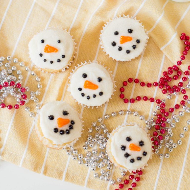 These adorable sparkly snowman cupcakes are the perfect recipe for Christmas baking with kids! This fun and easy cupcake recipe uses a boxed cake mix and simple decorating techniques that pack a big impact! #Christmas #ChristmasBaking #ChristmastCupcakes #Cupcakes #Snowman #SnowmanBaking #Homemade #Recipe #sweettreat