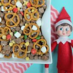 Yummy Chocolate Peanut Butter Cereal Christmas Snack Mix Next To Elf On The Shelf.