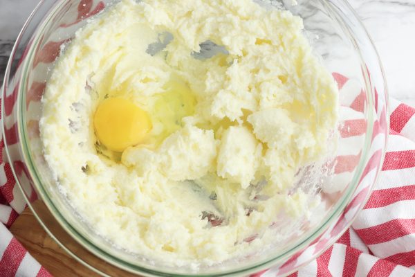In a large bowl, beat together the butter and sugar until light and fluffy. Add the eggs, one at a time, beating between each addition.