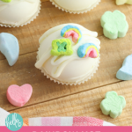 Have you jumped on the Hot Chocolate Bomb trend yet? These sweet treats are so fun and easy to make! Learn how to make rainbow hot chocolate bombs with this step by step tutorial! With Lucky Charms marshmallows they are magically delicious! Perfect for rainbow birthday parties favors or St. Patrick's Day!