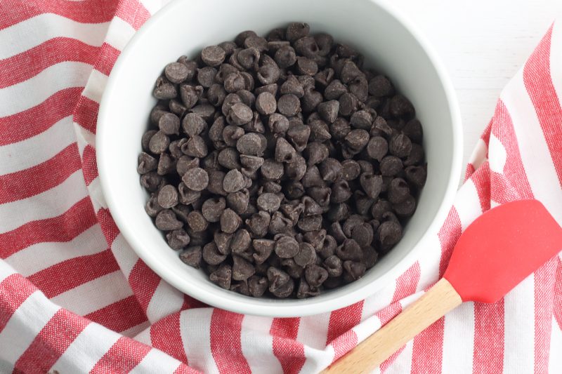Place the dark chocolate chips in a microwave safe bowl and microwave in 30 second intervals, stirring between each interval, until the chocolate chips are fully melted.
