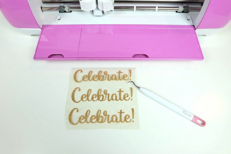 Gold Glitter HTV with the words celebrate and a weeding tool.