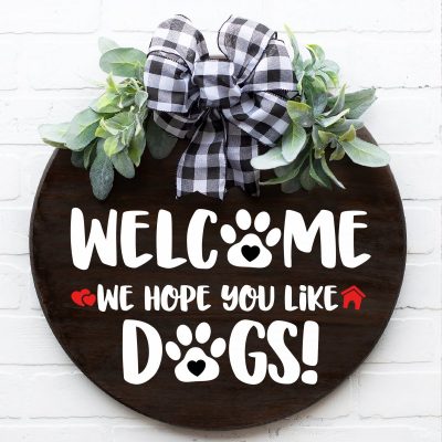 Make door signs, welcome mats and porch decor for your house with these 12 free door sign SVGS! Includes a Welcome We Hope You Like Dogs Cut File that is perfect for pet lovers and dog owners!