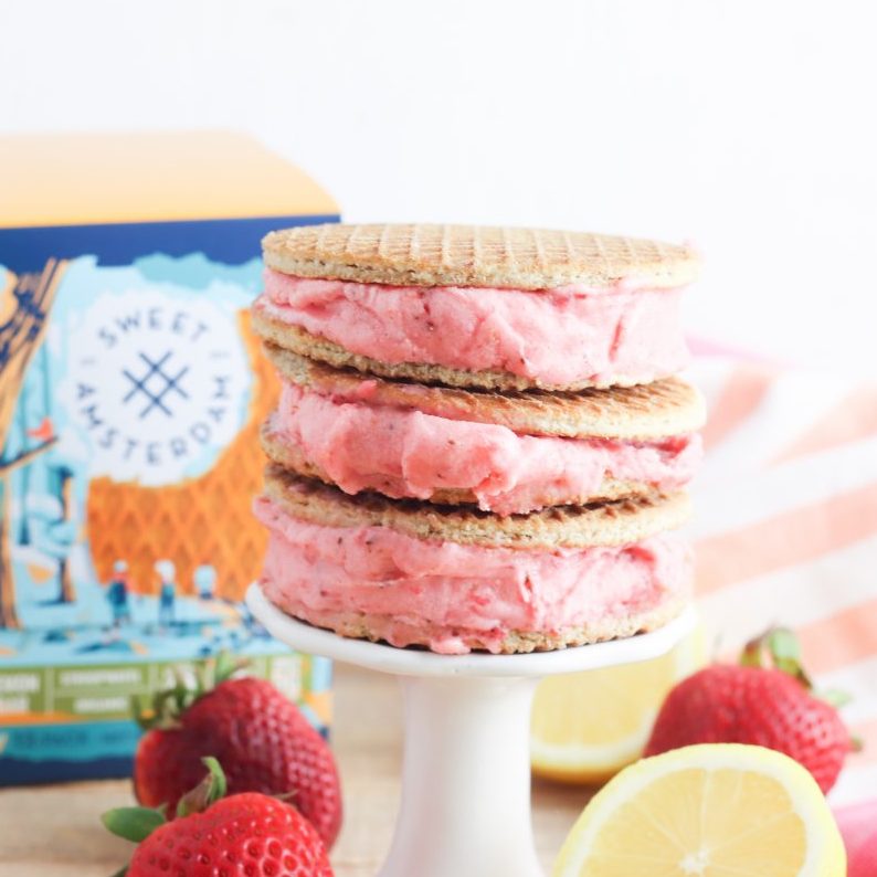 Oh. My. Yum! Get ready for all the flavors of summer with this delicious Strawberry Lemonade Sorbet Ice Cream Sandwich Recipe! Delicious and easy to make, this recipe uses Sweet Amsterdam lemon bar stroopwafel cookies as the sandwich and homemade sorbet using sweet summer strawberries as the filling! A delicious dessert idea that the whole family (kids and parents!) will love!
