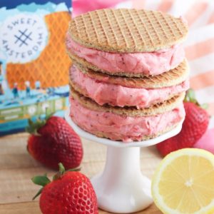 Oh. My. Yum! Get ready for all the flavors of summer with this delicious Strawberry Lemonade Sorbet Ice Cream Sandwich Recipe! Delicious and easy to make, this recipe uses Sweet Amsterdam lemon bar stroopwafels as the sandwich and homemade sorbet using sweet summer strawberries as the filling! A delicious dessert idea that the whole family (kids and parents!) will love!