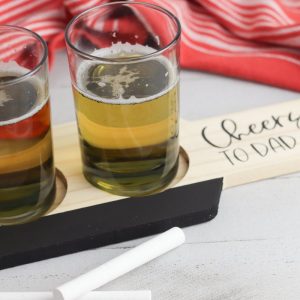 Place the small glasses on the board and use the chalk to write the type of beer in each glass.