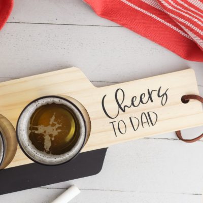 The perfect handmade gift idea for beer lovers! We're showing you how to make a DIY Beer Flight Board using your Cricut Maker, Cricut Explore or Cricut Joy and some chalk paint and vinyl scraps! This is a fun and easy handmade gift idea for dad that takes just minutes to make! He will love it and use it over and over and over again! Perfect for Father's Day, Christmas and birthdays!