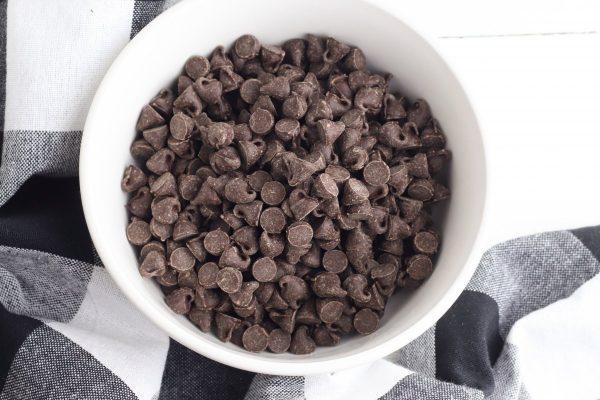 Place the milk chocolate chips in a microwave safe bowl and microwave in 30 second intervals, stirring between each interval, until the chocolate chips are fully melted.