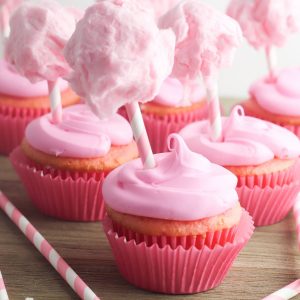 Capture those summer dessert time feelings all year long with this delicious, stuffed cotton candy cupcakes recipe! This yummy dessert is quick and easy to make using a boxed cake mix, but the decorations take it over the top giving it a super fun carnival twist! A fun dessert idea for birthday parties and baby showers!