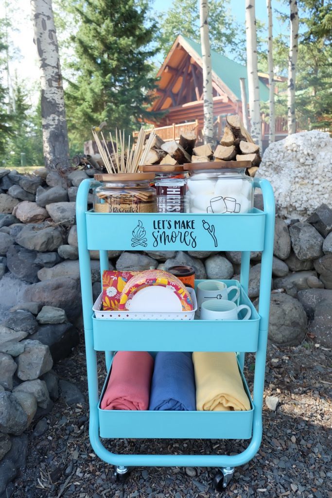 DIY Smores Cart in front of beautiful log cabin