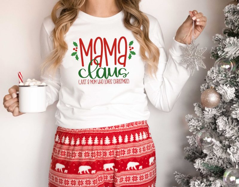 Woman decorating a Christmas tree wearing a DIY Mama Claus t-shirt