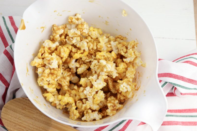 Carefully stir the cereal and popcorn until it’s fully coated in the caramel sauce. Give it a little toss, toss, toss and a shake, shake, shake to make sure your caramel sauce gets in all those nooks and crannies!