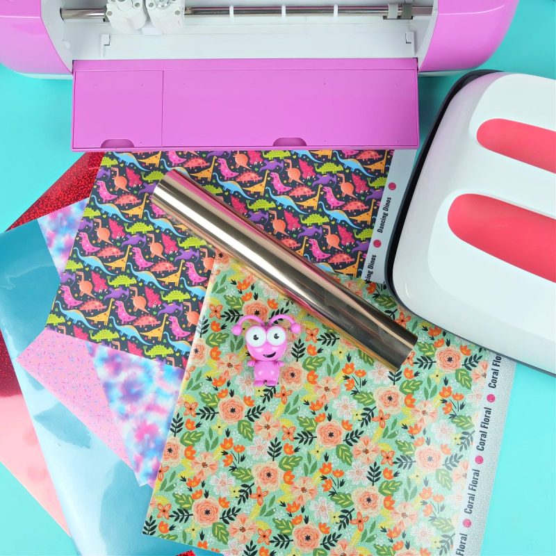Cricut with selection of vinyl and htv sheets and rolls