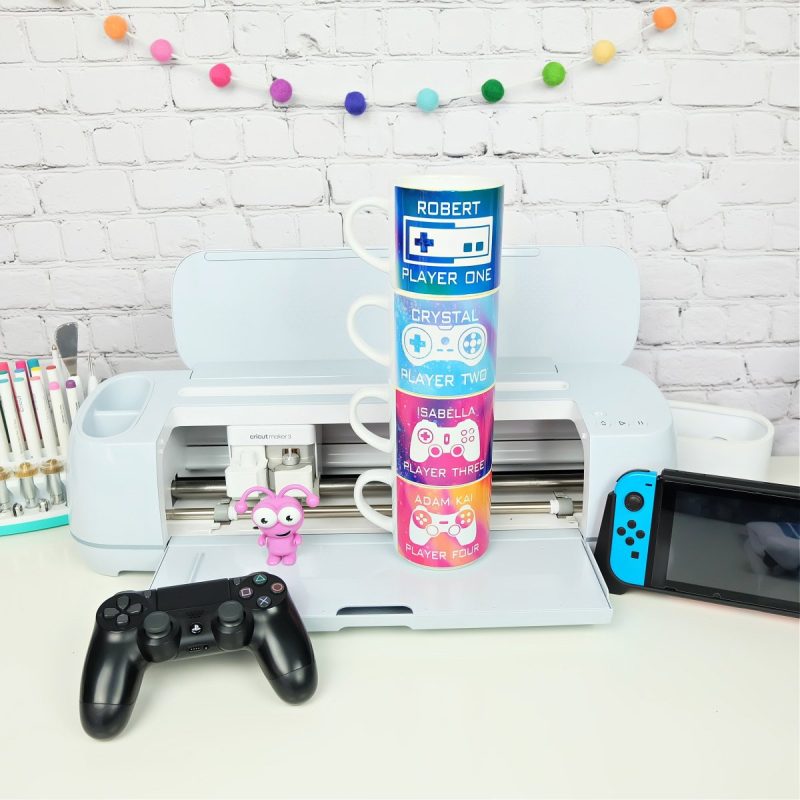 Know a dad who loves video games? We're sharing 3 DIY Father's Day Cricut Ideas that gamer dads will love! We're sharing how to make a Leveled Up To Dad hat, a Dad By Day, Gamer By Night shirt and a set of stackable mugs with video game remotes, each family member's name and a player number that relates to their birth order! Pull out your Cricut Maker, Cricut Explore or Cricut Joy and Infusible Ink and let's get crafting!