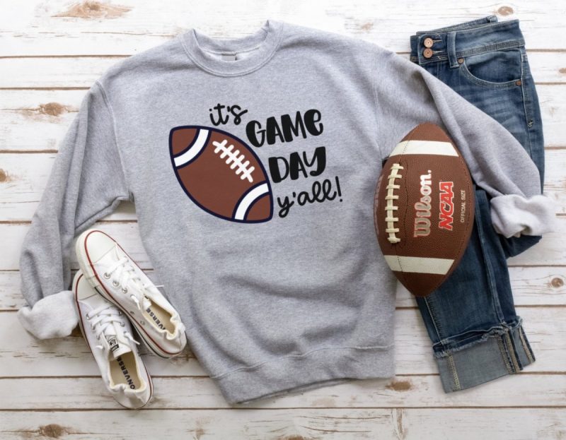Make a DIY football sweatshirt that says "It's Game Day Y'all" using your Cricut cutting machine. 