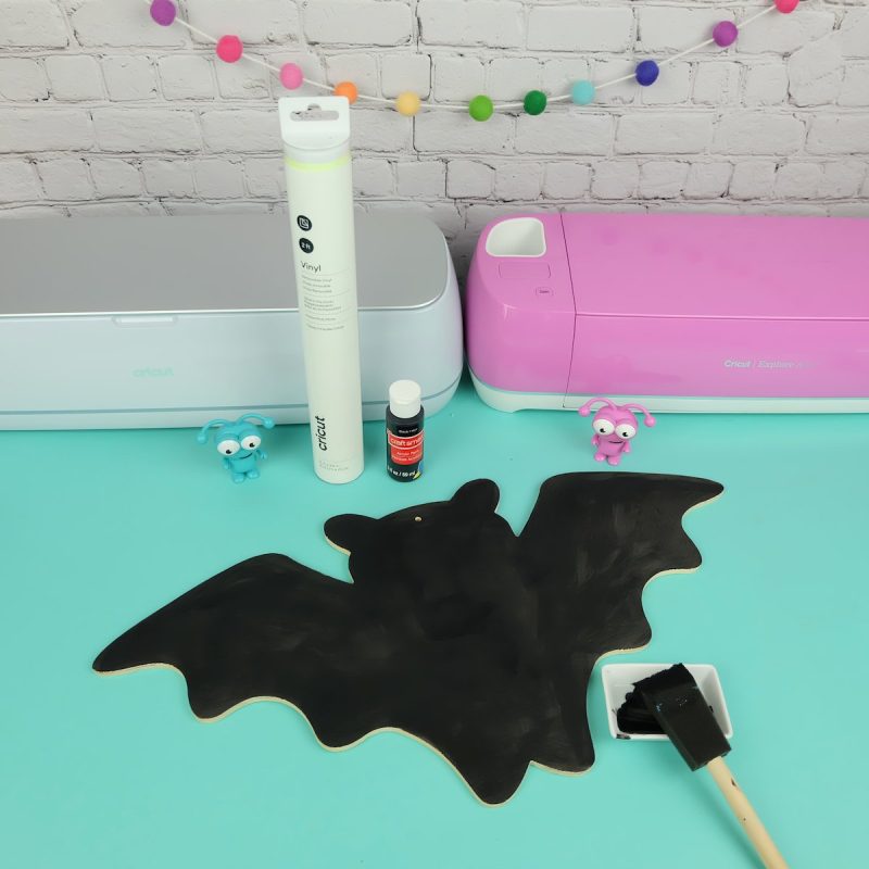 Paint your wood bat sign using black acrylic paint and a paint brush. I did two coats and allowed it to dry thoroughly between each coating. I recommend allowing your paint to dry for 24 hours before adding vinyl to it.