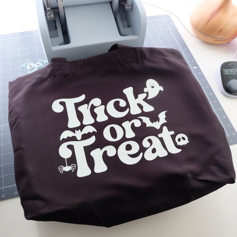 Check the Cricut temperature guide for the pressing instructions for the fabric of bag you are using. My bag was made of polyester so I pre-heated my Cricut Autopress to 305 degrees. Once my press came to temperature I pressed my bag for 5 seconds. Then I laid my design on my bag where I wanted it, covered it with an iron-on protective sheet and heated for 40 seconds.
