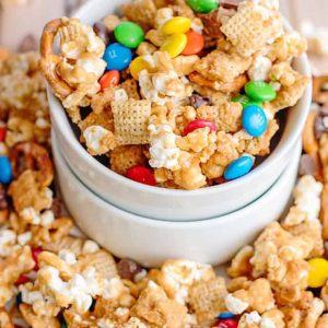 This caramel chex mix recipe is loaded with pretzel twists, sweet caramel flavor, Chex, popcorn, and more. It is great for the holidays and you can add red and green m&ms for a festive touch! 