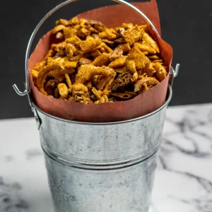 This sweet and spicy smoked Chex mix recipe is a new holiday favourite! It combines a warming sriracha caramel with a hint of smoke for a delicious smoked party mix.