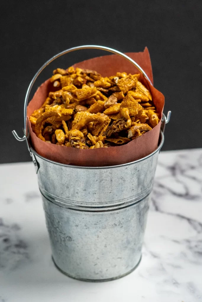This sweet and spicy smoked Chex mix recipe is a new holiday favourite! It combines a warming sriracha caramel with a hint of smoke for a delicious smoked party mix.