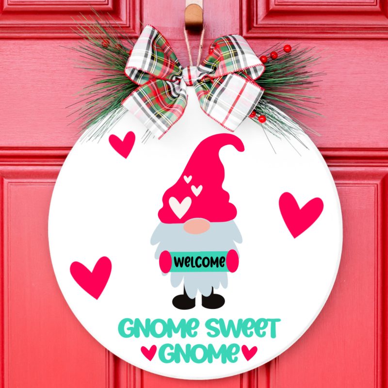 Wood sign hanging on red door with an adorable Gnome Sweet Gnome design on the sign.