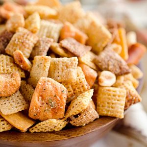 This cheesy Chex Mix is loaded with crunchy cheddar pretzels, nuts and tossed with zesty ranch seasoning for great flavor. 