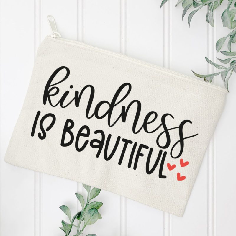 DIY cosmetic bag with Kindness Is Beautiful on front using HTV and free Kindness SVG from Hello Creative Family