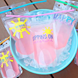 Celebrate summer with a cool beverage! Learn how to make DIY Color Changing Drink Pouches using Cricut color changing vinyl! These drink pouches are reusable and decorated with the cutest summer SVG files! A fun and easy Cricut summer craft project that you can make with your Cricut Maker, Cricut Explore Air or Cricut Joy!