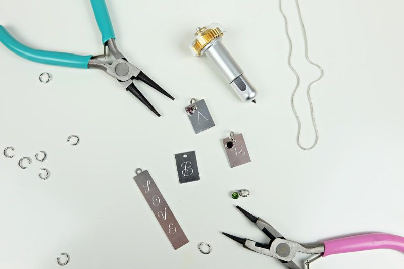 Use your jewelry pliers to add jump rings and birthstones to the charms you&rsquo;ve just engraved. Put them on your necklace.