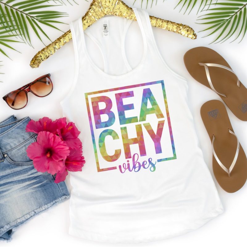 White tank top with the words beachy vibes on the front in rainbow design. 