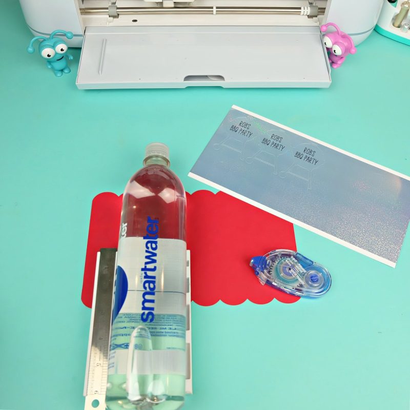 Pieces of a Cricut BBQ water bottle wrap laying on a work surface waiting to be assembled