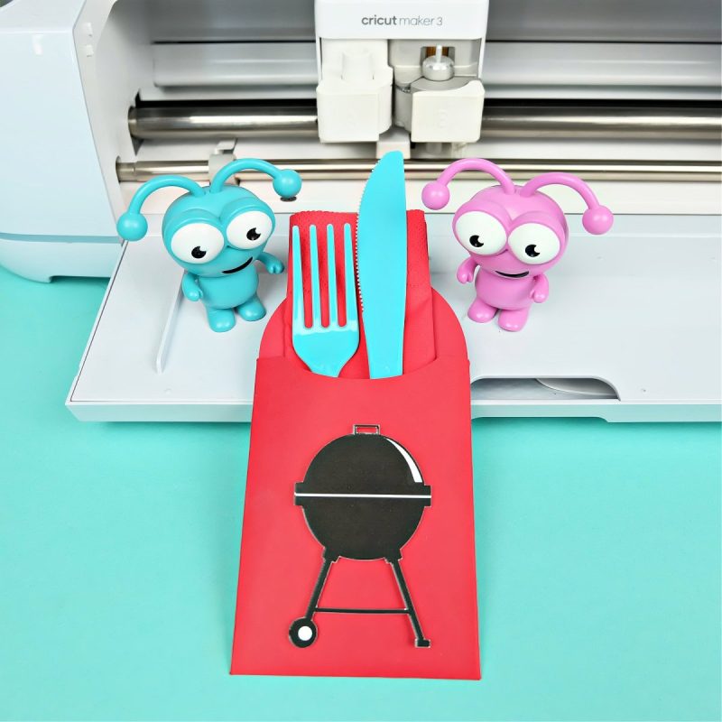 BBQ Utensil Holder sitting in front of a Cricut Maker 3 with two Cricut cuties