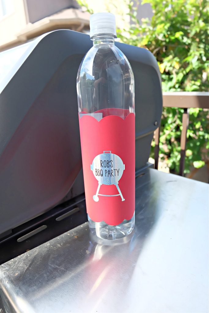 Cricut BBQ water bottle wrap sitting next to a BBQ.