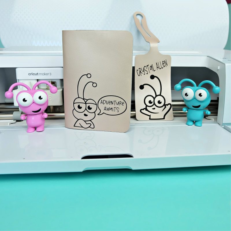 Cricut passport holder and luggage tags with Cricut Cutie design on the front.
